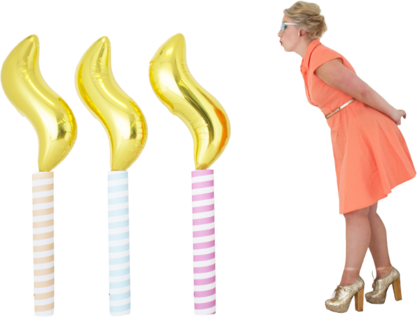 woman blowing balloon candles out